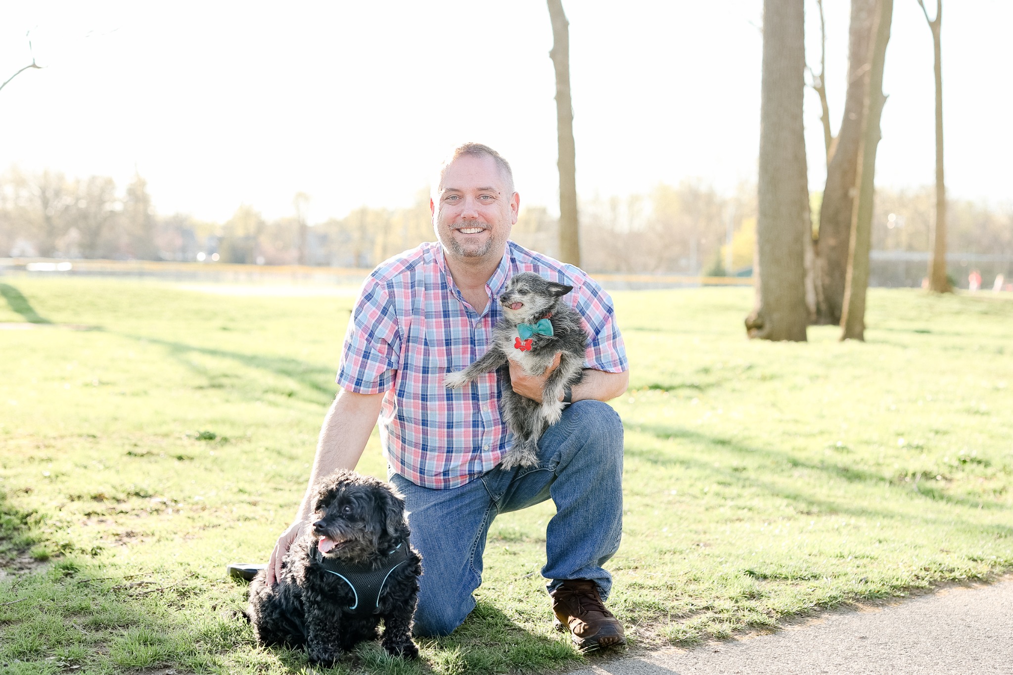 Steve outdoors with Tucker beside him and Ike in his arms